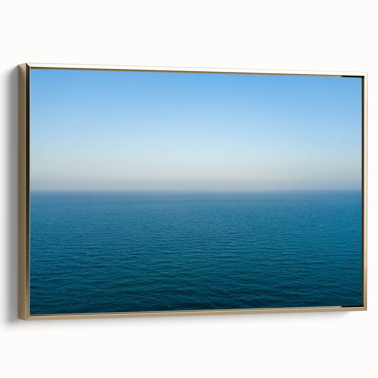 Landscape painting of the Mediterranean Sea on a framed canvas, featuring soft blue and gold tones.