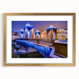 Abstract art print of a European cityscape in muted gray and gold tones on a framed canvas.