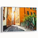 Vintage poster art of Stockholm with colorful buildings on black framed canvas, ideal for living room decor.