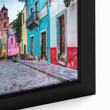 Black framed canvas of textured, colorful Guanajuato scenery, ideal for living room decor.