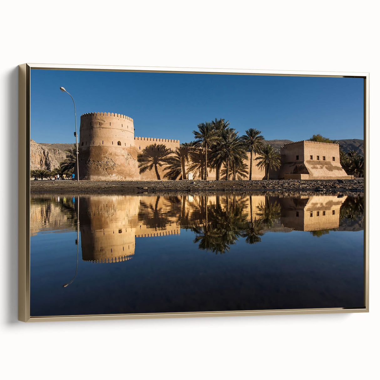 Framed canvas depicting a vintage-style landscape of Oman, in muted gold and black tones, ideal for bedroom wall decor.
