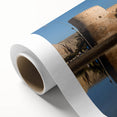 Art deco poster of Middle Eastern scenery on rolled canvas, featuring muted earth tones.