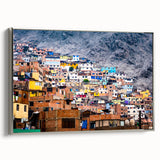 Framed canvas depicting a vintage-style landscape of a Peruvian scene with colorful art and black borders.