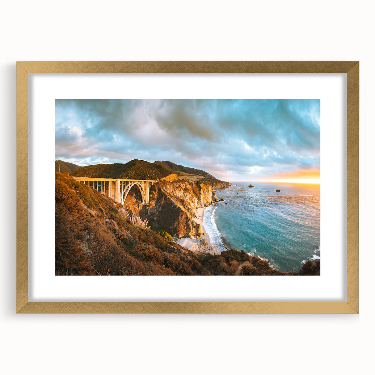 Extra large abstract art print of Big Sur coastline in vibrant blue and green hues on a textured canvas, framed in gold.