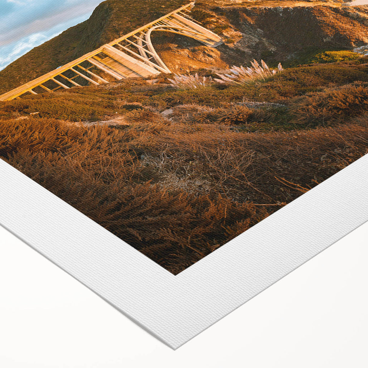 Art deco poster of California's Big Sur in muted green and blue tones on a rolled canvas, suitable for dining room decor.