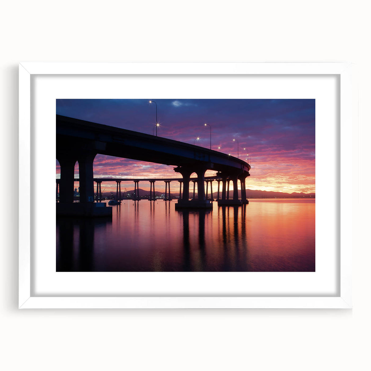 Abstract art print depicting the Coronado, California skyline in muted blue and gray tones on a framed white mat.
