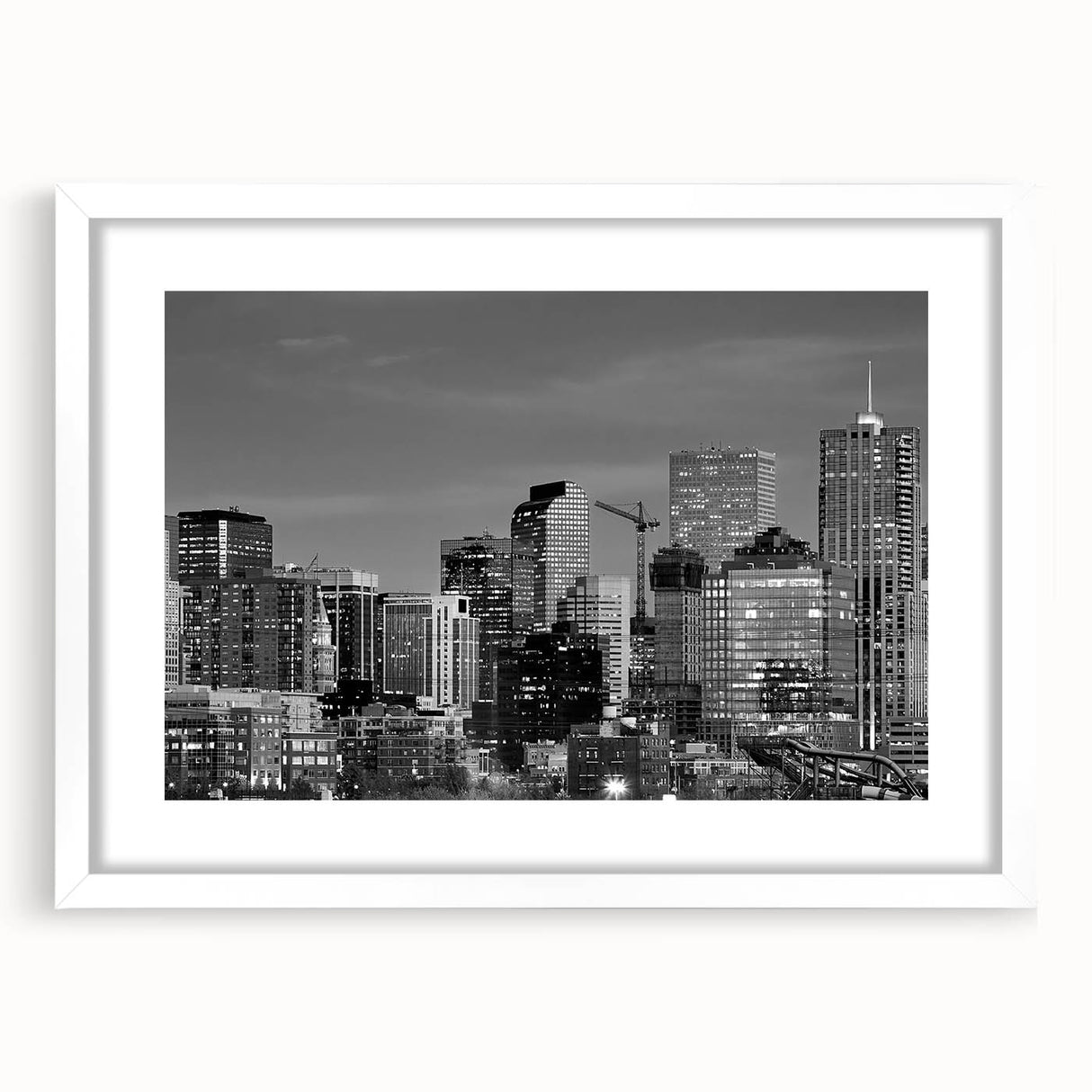 Abstract art print of Denver skyline in muted gray and blue tones on a white-framed canvas, ideal for dining room decor.