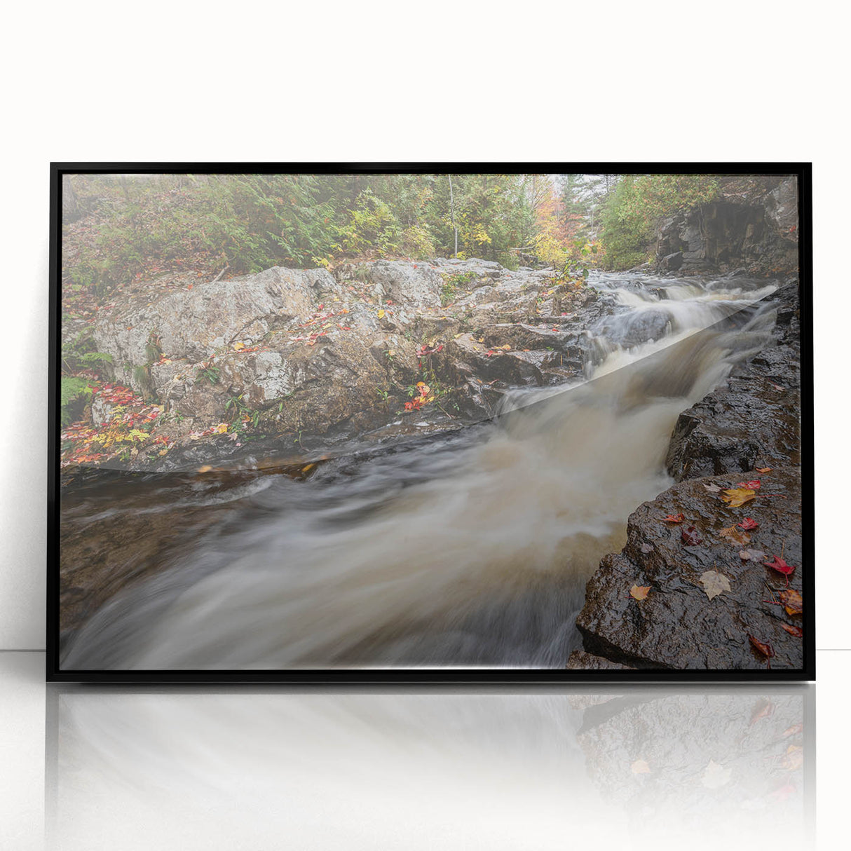 Large abstract wall art depicting Acadia's rocky coastline in muted earth tones on a black framed acrylic.