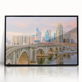 Large abstract wall art depicting the Minneapolis skyline in muted blue and gray tones, presented in a black framed acrylic.