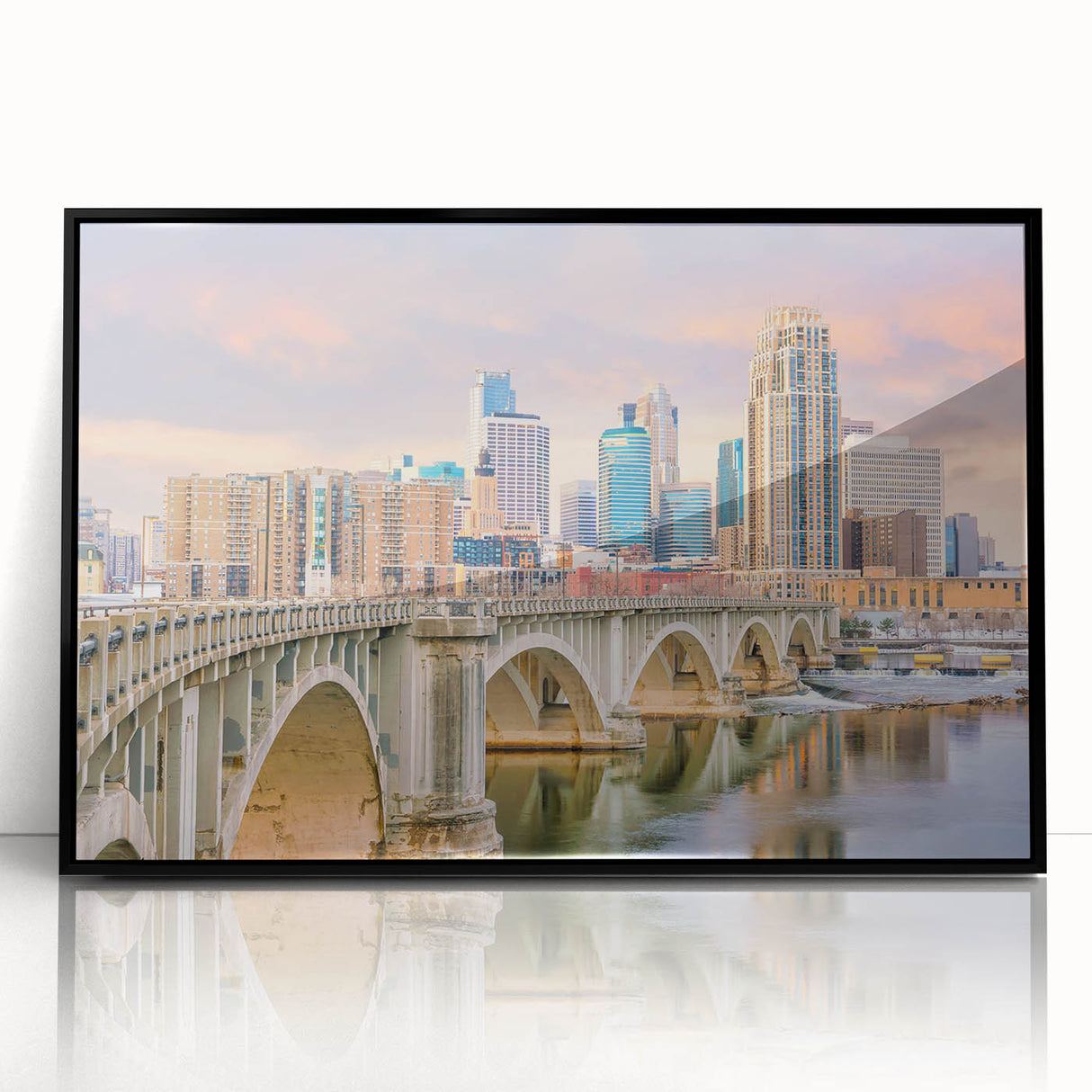 Large abstract wall art depicting the Minneapolis skyline in muted blue and gray tones, presented in a black framed acrylic.