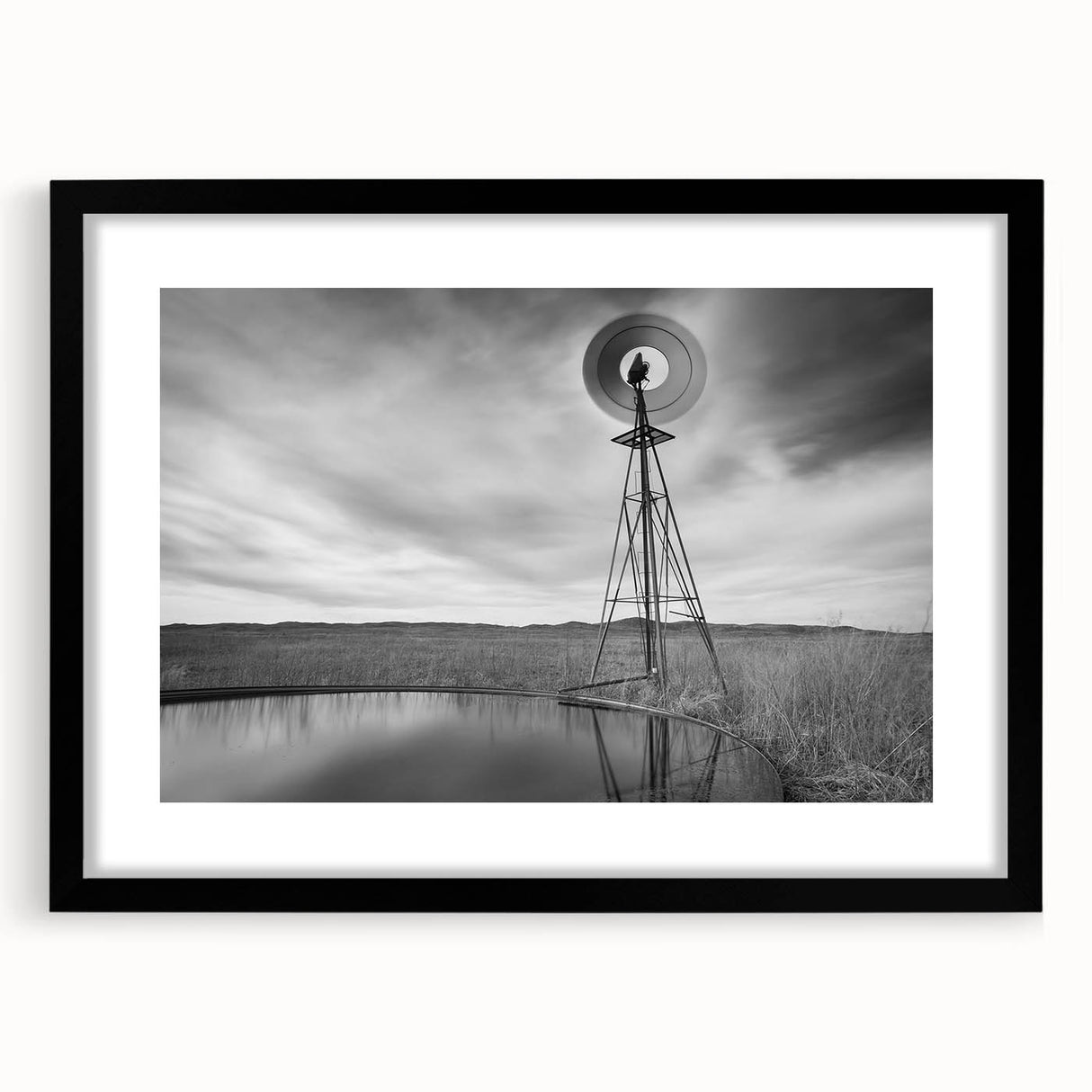 Abstract art print of textured, colorful Nebraska scenery on a large canvas, framed in black, ideal for living room decor.