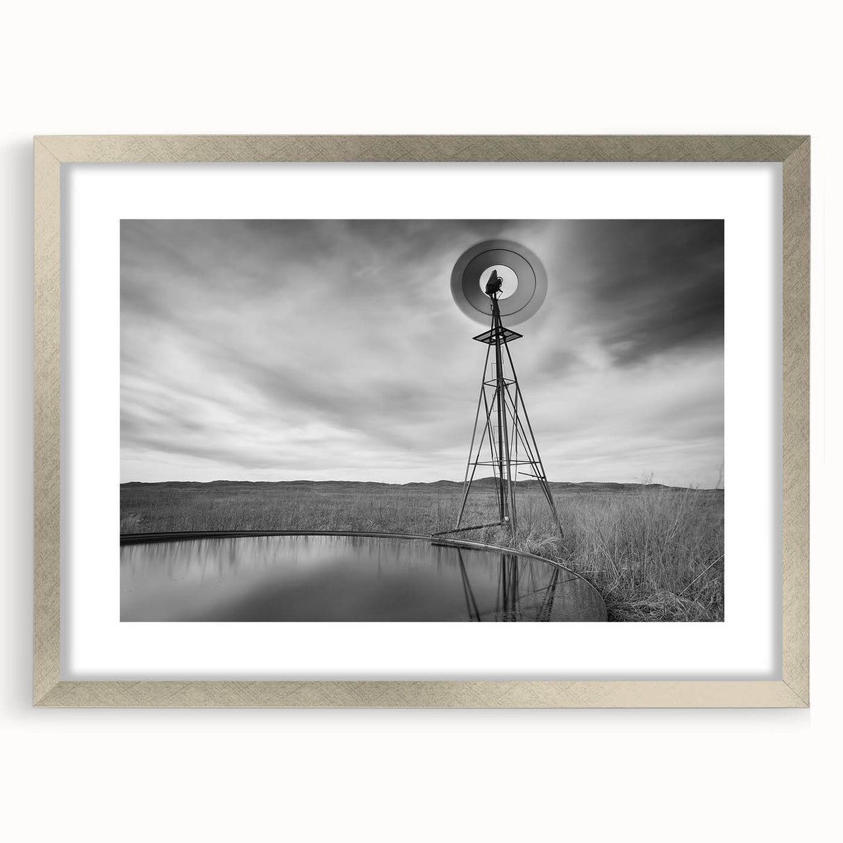 Textured abstract art print of Nebraska scenery in muted earth tones, framed in silver, suitable for bedroom decor.