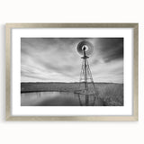 Textured abstract art print of Nebraska scenery in muted earth tones, framed in silver, suitable for bedroom decor.