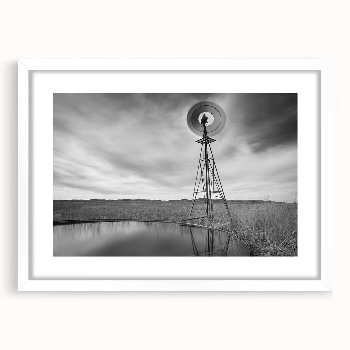 Abstract art print depicting a rural Nebraska landscape in muted earth tones on a framed white mat.