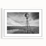 Abstract art print depicting a rural Nebraska landscape in muted earth tones on a framed white mat.