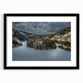 Colorful abstract art print of the Adirondacks in vibrant hues, framed in black, ideal for living room decor.