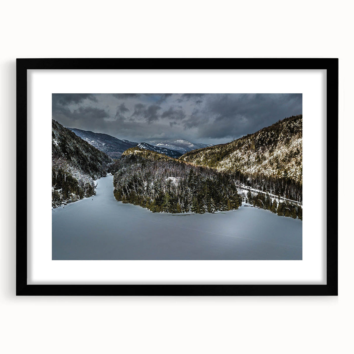 Colorful abstract art print of the Adirondacks in vibrant hues, framed in black, ideal for living room decor.