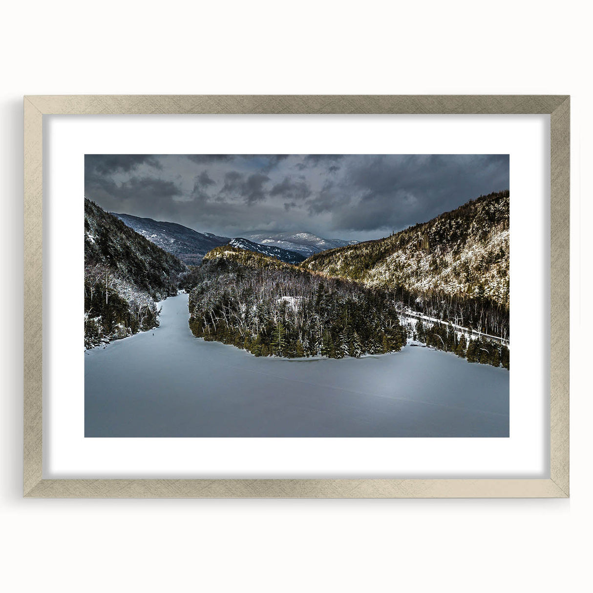 Textured art print of abstract Adirondacks scenery in silver frame, using muted earth tones, ideal for bedroom decor.