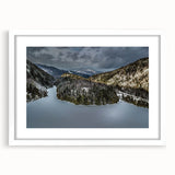 Abstract art print of Adirondack scenery in muted green and blue tones, framed in white, suitable for dining room decor.