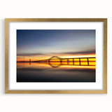 Extra large abstract art print of a textured seaside landscape in muted blues and greens, framed in gold.