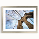 Textured art of the Brooklyn Bridge in muted gray and blue tones on a framed poster, suitable for bedroom art.