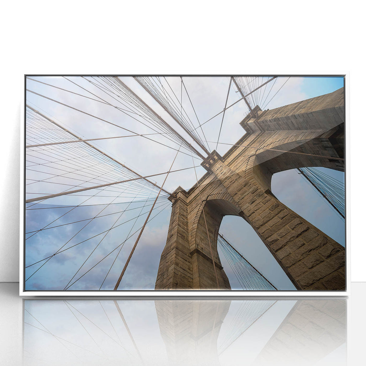 Acrylic print of Brooklyn Bridge in muted gray and blue tones, framed in white, suitable for modern art wall decor.