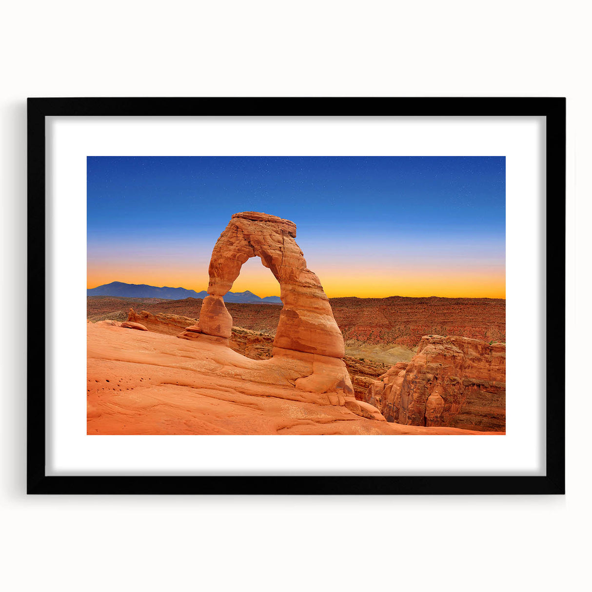 Extra large wall art featuring a colorful abstract depiction of Utah's Arches, in a black frame, ideal for living room decor.