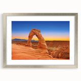 Textured art print depicting abstract Arches National Park scenery in earth tones on a framed silver mat.