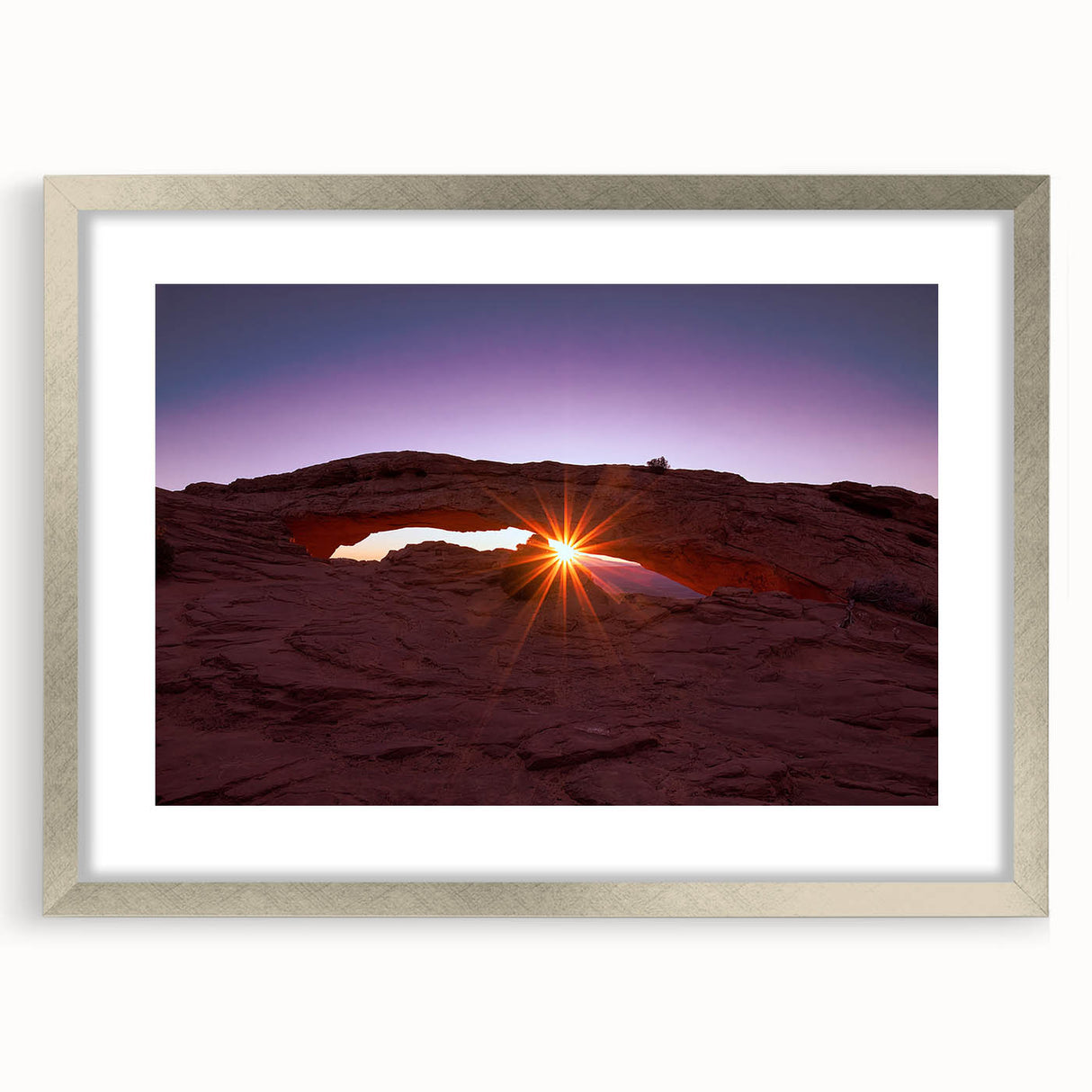 Textured art of Canyonlands with abstract design in earthy tones on a silver-framed mat, ideal for bedroom decor.