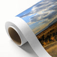 Art deco poster of Grand Tetons on rolled canvas, with muted earth tones, ideal for nursery wall art.