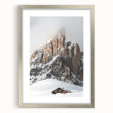 Textured abstract art print depicting a winter scene in muted blue and white tones, framed in silver, ideal for bedroom art.