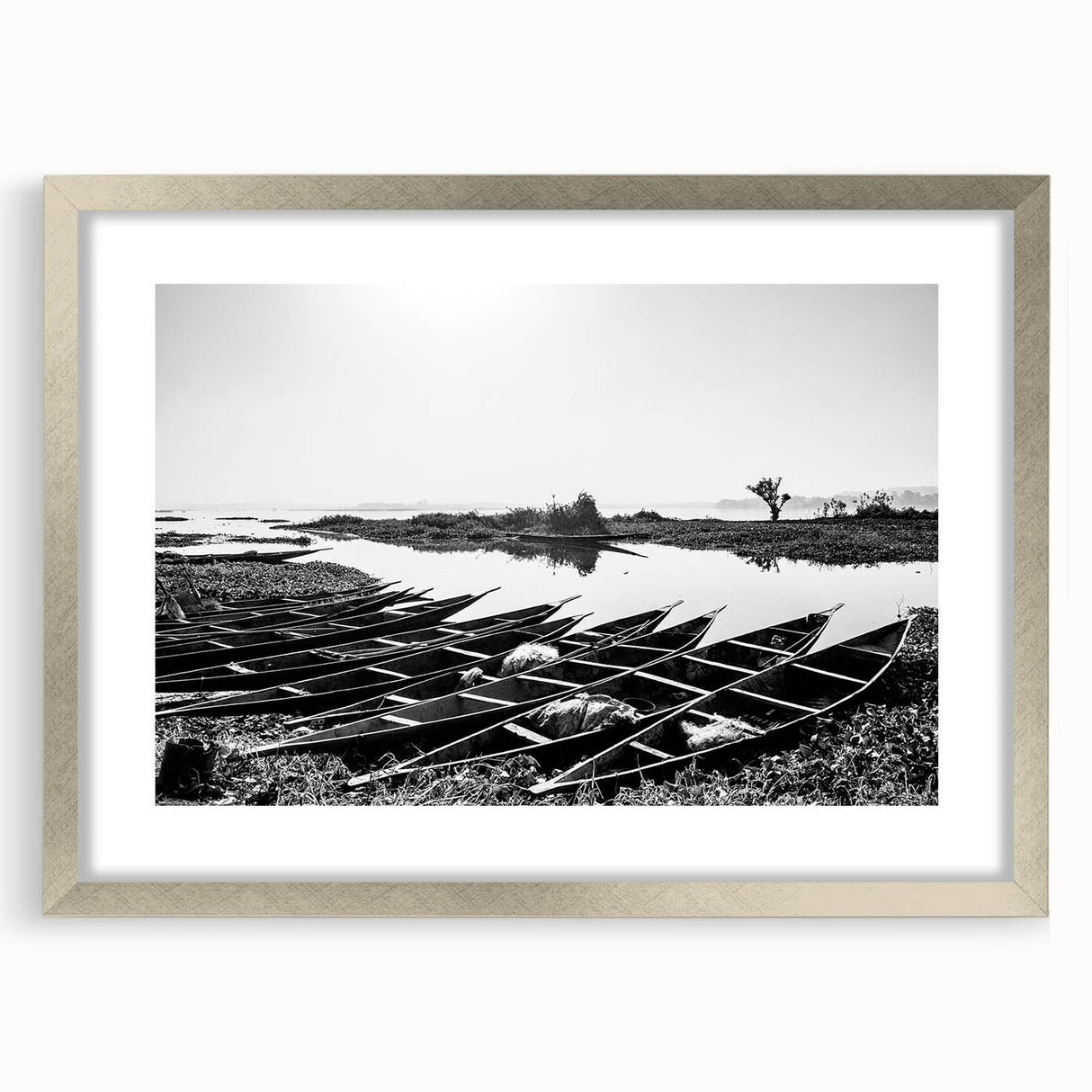 Abstract art print of an African Mali scenery in muted earth tones on a framed silver matte canvas.