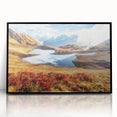 Large abstract wall art depicting a vibrant, geometric landscape in shades of orange and blue, framed in black acrylic.