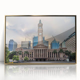 Framed acrylic print of Brisbane skyline featuring mid-century modernist art style with gold and blue tones.