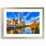 Abstract art print of Melbourne skyline in muted blue and gray shades on a framed silver canvas.
