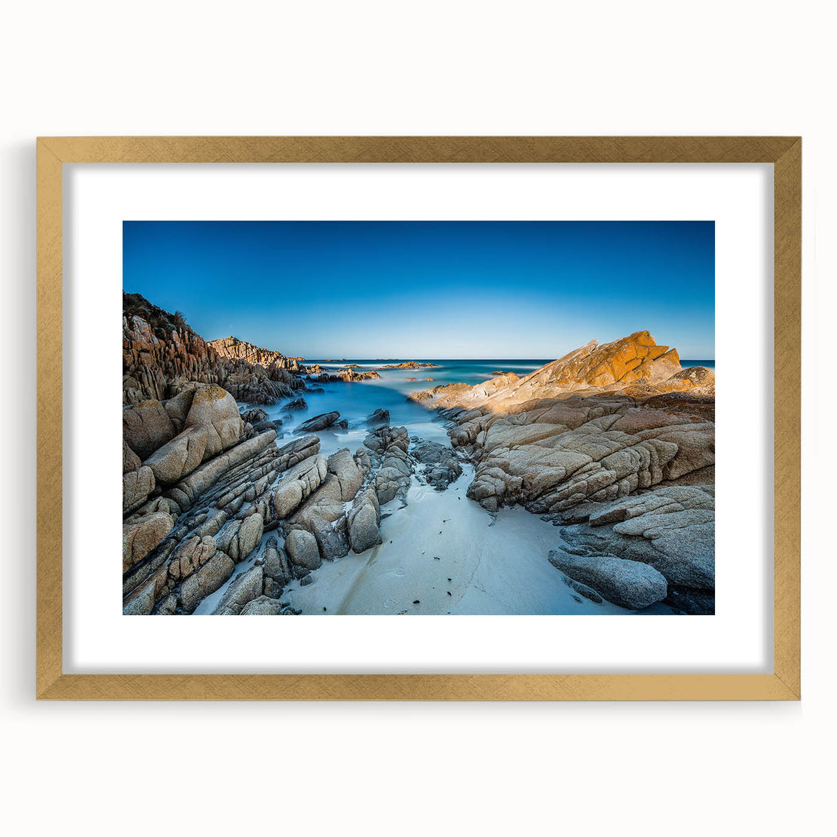 Textured art of abstract scenery in Tasmania, featuring earthy tones on a framed gold mat, suitable for bedroom decor.