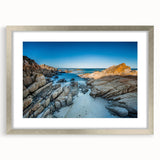 Abstract art print depicting a Tasmanian landscape in muted green and brown tones, framed in silver.