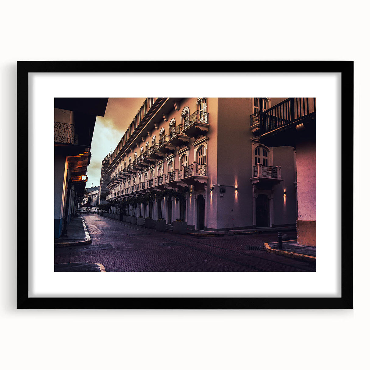 Extra large abstract art print featuring textured, colorful art of a Central American scenery in a black frame.