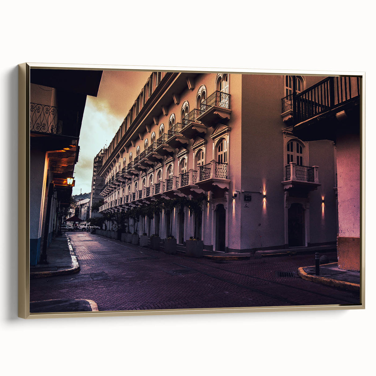 Framed canvas featuring a vintage-style landscape painting of Central America with black and gold tones.