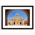 Colorful abstract art print of a European scenery, in vibrant blues and whites on a textured canvas, framed in black.