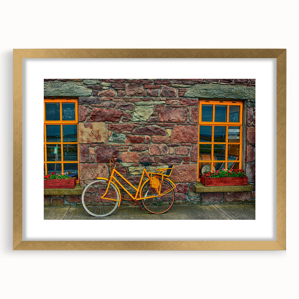 Abstract art print depicting a scenic Irish landscape in muted green and earth tones, framed in gold.