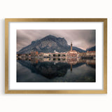 Abstract art print of Lake Como with muted blue and green tones on a framed gold mat, suitable for dining room decor.