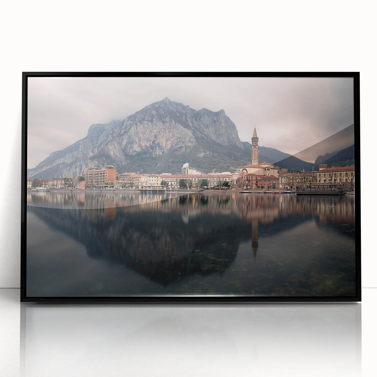 Large abstract wall art of Lake Como with muted blue and green tones on a framed acrylic, ideal for modern living room decor.