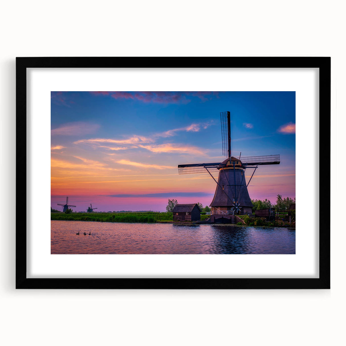 Abstract art print of a colorful European landscape, textured on a large black-framed canvas, ideal for living room decor.