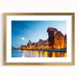 Abstract art print of a European scenery in muted gold and blue tones, framed with a golden mat, ideal for dining room decor.