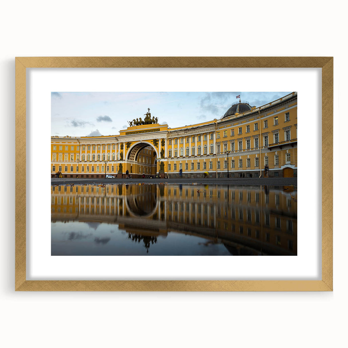 Abstract art print of a European cityscape in muted gold and black tones, framed with a gold mat.
