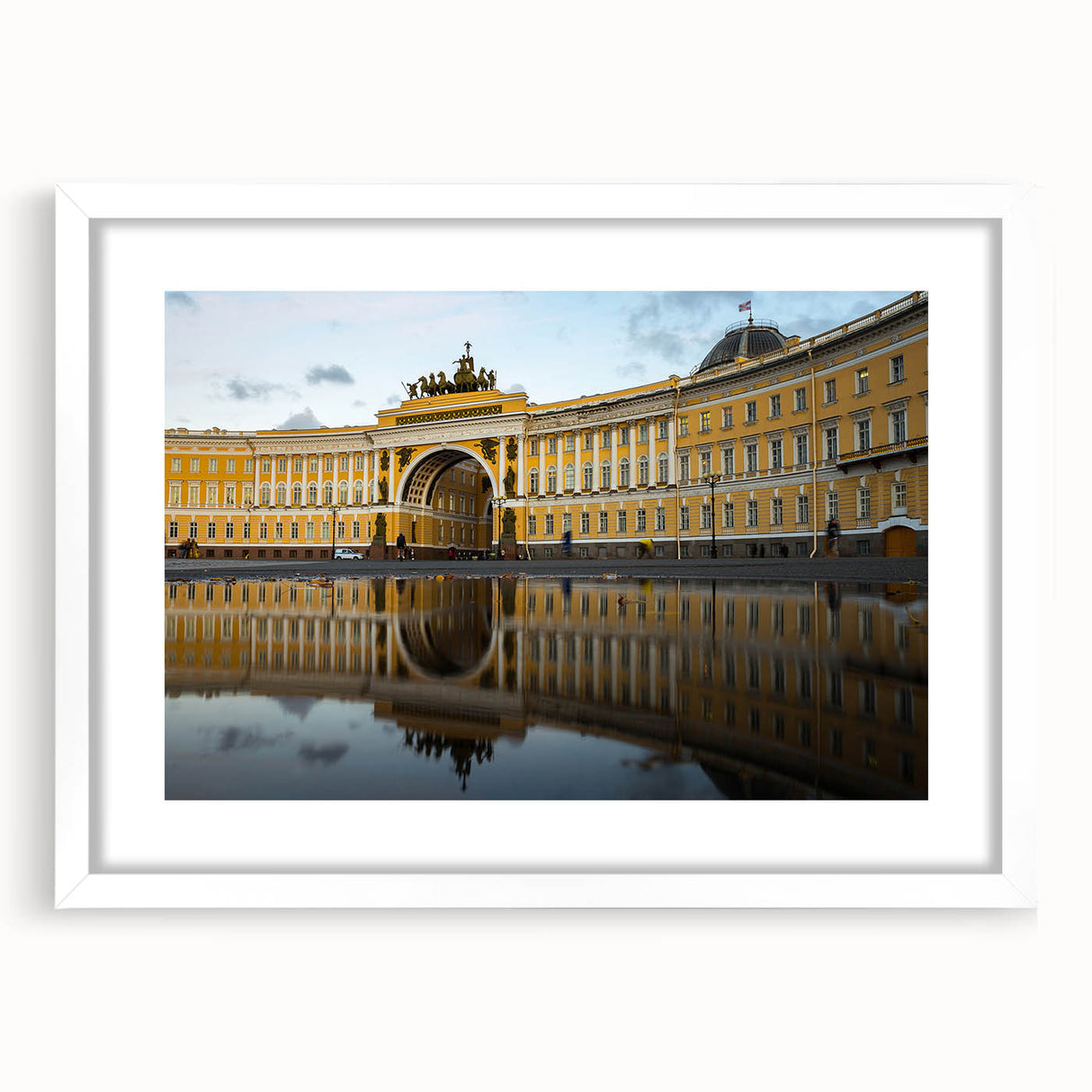 Textured abstract art print of a European cityscape in muted gray and blue tones, framed with a white mat.