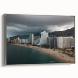 Landscape art painting of Acapulco coastline in a silver-framed canvas, with vibrant colors on a black background.