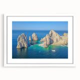 Abstract art print of Cabo San Lucas with vibrant blue and green tones on a framed white mat, suitable for dining room decor.