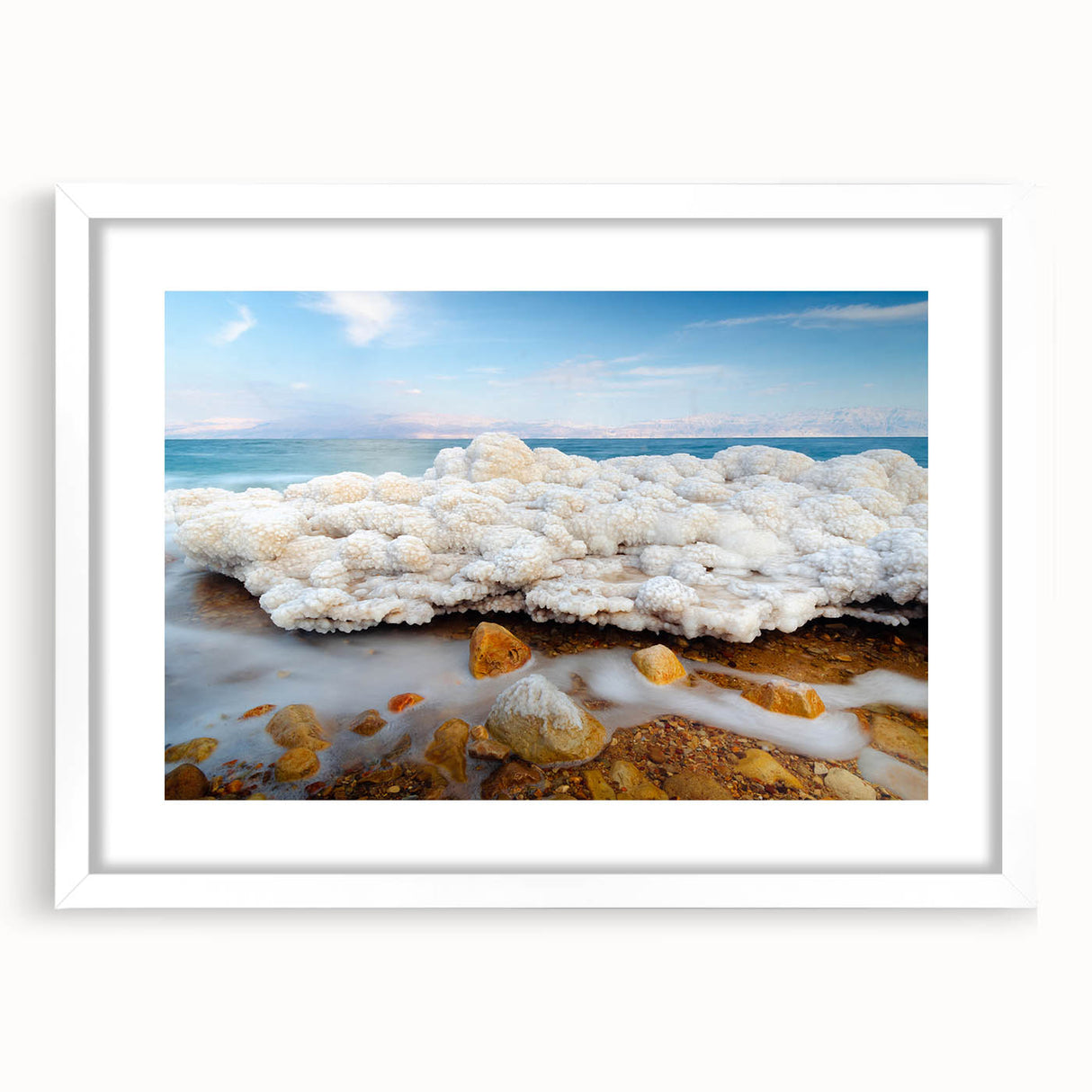 Abstract art print of the Dead Sea in muted blues and grays, framed in white, ideal for dining room decor.